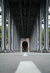 Rear view of person walking on bridge