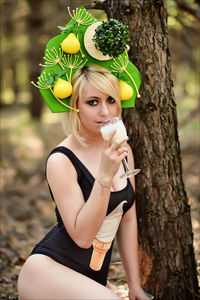 Portrait of young woman with flower tree