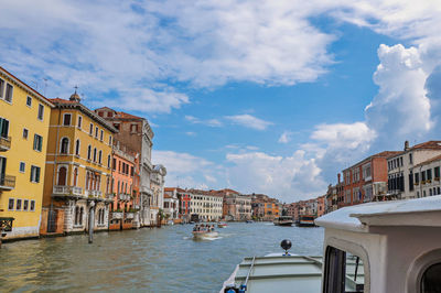View of the grand canal with boats and buildings on the bank, at the city of venice in italy.