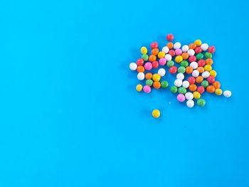 High angle view of multi colored ball on blue background