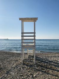 Lifeguard hut on beach against clear sky