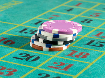 Gambling chips on roulette table in casino