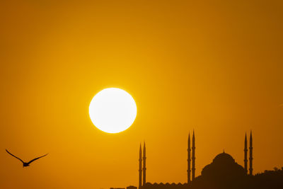 Low angle view of silhouette yellow against orange sky