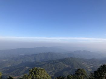 Scenic view of mountains against blue sky