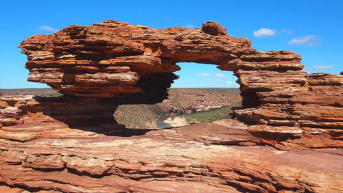 View of rock formation against blue sky