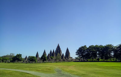 Scenic view of field against clear blue sky