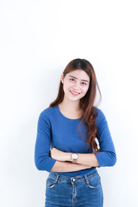 Portrait of a smiling young woman against white background