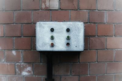 Close-up of mailbox on brick wall