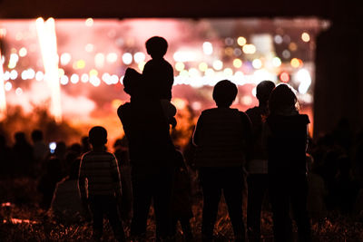 Rear view of silhouette people at music concert