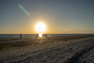 Scenic view of beach against sky during sunset