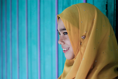 Smiling young woman in hijab looking away
