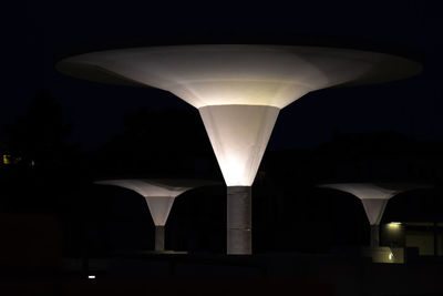 Close-up of illuminated lights against sky