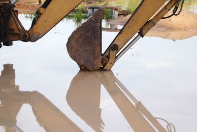 Low angle view of old machinery against sky