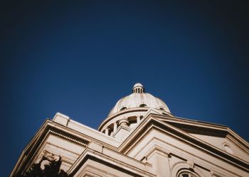 Low angle view of temple against clear blue sky