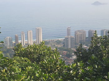 High angle view of buildings and sea in city