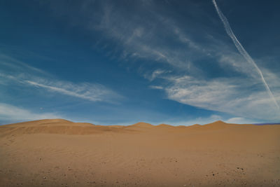 Scenic view of desert against sky during sunset