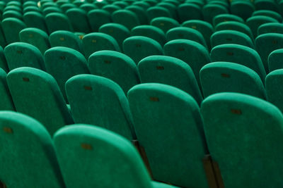 Classic rows of empty green seats in the theater. hall without visitors.