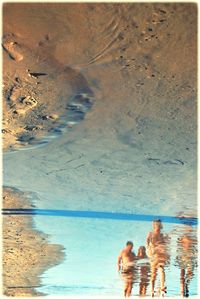 Men swimming in sea