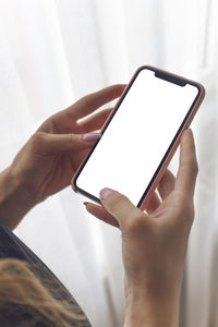 Midsection of person holding mobile phone