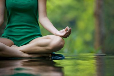 Low section of man sitting in water
