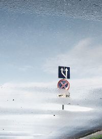 Road sign on snow covered land