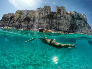 Surface level of woman swimming in sea