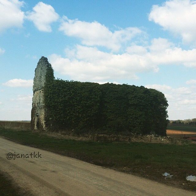 VIEW OF BUILT STRUCTURE AGAINST CLOUDY SKY