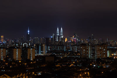 High angle view of city lit up at night