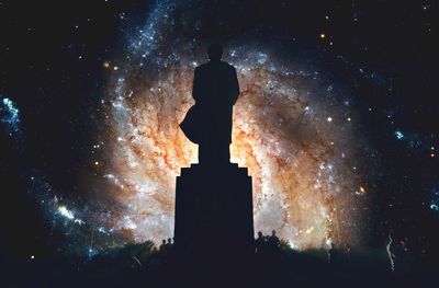 Low angle view of silhouette statue against sky at night