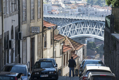 People on street amidst buildings in city