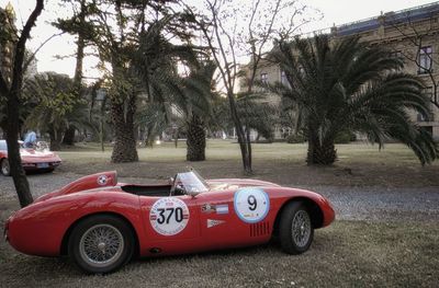 View of red car on field