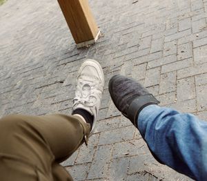 Low section of man standing on footpath