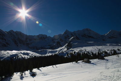 Scenic view of snowcapped mountains against sky during winter