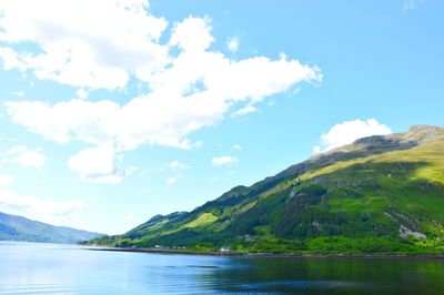 Scenic view of lake and mountains against sky