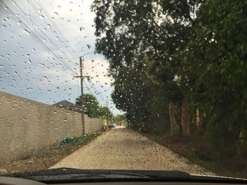 Road seen through wet car window