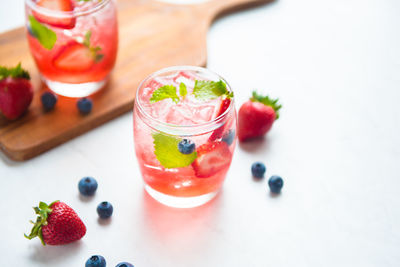 Close-up of fruits and drink on table