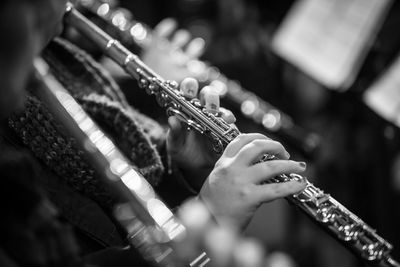 Close-up of person playing flute