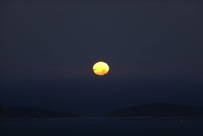 Scenic view of moon against clear sky at night