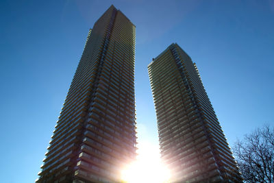 Low angle view of modern building against clear blue sky