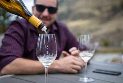 Man having wine in glass at table