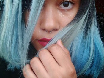 Close-up portrait of young woman with dyed hair