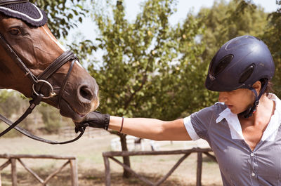 Close-up of woman holding horse