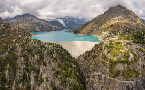 Scenic view of sea and mountains against sky