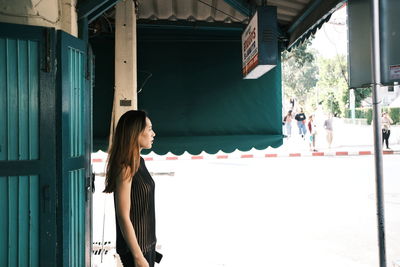 Woman standing against building