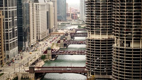 High angle view of drawbridges over chicago river amidst buildings in city