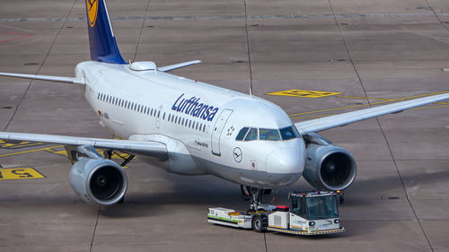 High angle view of airplane at airport runway