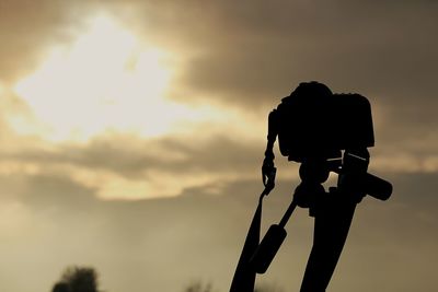 Low angle view of silhouette pole against sky during sunset