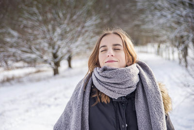 Portrait of woman standing in snow