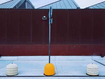 Close-up of bell hanging on wall by building