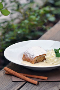 High angle view of dessert by cinnamons on table